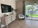 Cozy living room with stylish decor, tile floors, and sliding glass doors to an outdoor patio at 4444 Aqua Mirage St, Sarasota, FL 34238