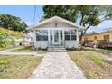 Inviting home exterior with paver walkway, manicured lawn, and stylish front door at 504 Cleveland Ave, Largo, FL 33770