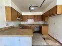 Kitchen featuring wood cabinets, laminate countertops, and a sink, ready for customization at 5124 Chilkoot St, Tampa, FL 33617