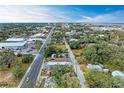 Nice aerial view of the neighborhood showing a road leading to the city with trees on either side and clear blue sky at 613 6Th E Ave, Bradenton, FL 34208