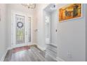Inviting foyer with decorative glass front door and wood look flooring at 6227 Golden Nettle Dr, Apollo Beach, FL 33572