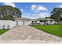 Beautiful home with a driveway leading to a two-car garage and meticulously maintained landscaping at 7224 Park S St, St Pete Beach, FL 33707