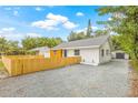 Well-maintained home with a gravel driveway and a detached garage offers privacy and convenience at 731 38Th N Ave, St Petersburg, FL 33704