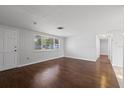 Inviting living room with hardwood floors, natural light, and neutral wall color at 7330 Abalone Dr, Port Richey, FL 34668