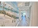 Inviting hallway with coastal-themed decor and modern flooring at 7564 Bayshore Dr # 202, Treasure Island, FL 33706