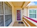 Close-up of a condo entrance featuring a secure door and a cozy, private landing area at 7823 Hardwick Dr # 224, New Port Richey, FL 34653