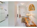Bright hallway featuring tile flooring and access to the kitchen, bathroom, and living areas at 7823 Hardwick Dr # 224, New Port Richey, FL 34653