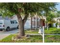 A charming home with a well-manicured lawn, mature tree, and a white mailbox, exuding curb appeal at 814 Cape Cod Cir, Valrico, FL 33594