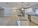 Open kitchen featuring granite counters, stainless appliances, and pendant lighting at 12372 113Th St, Largo, FL 33778