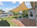 Relaxing backyard patio space featuring a shade cover, seating, and access to the waterfront at 13323 Susan Dr, Hudson, FL 34667