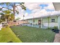 The backyard has an artificial lawn and a covered patio at 13929 Muriel Ave, Hudson, FL 34667