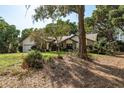 Charming single-Gathering home with well-maintained lawn and landscaping, complemented by mature trees at 14449 Wadsworth Dr, Odessa, FL 33556