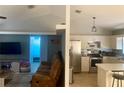 Open-concept living room with seamless flow to the kitchen and a comfortable seating arrangement at 1602 Taylor Lake Cir, Largo, FL 33778