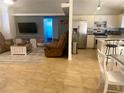 Open layout showcasing the living room and kitchen with tile flooring throughout at 1602 Taylor Lake Cir, Largo, FL 33778