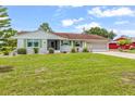 A charming single-story home featuring a well-kept lawn and an attached two-car garage at 1609 Pebble Beach N Blvd, Sun City Center, FL 33573