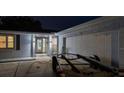 A garage and door well-lit at night, next to a trailer at 1675 Eden Ct, Clearwater, FL 33756