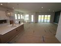 Spacious living room with an open floor plan, natural light, and modern fixtures at 18033 Foxtail Loop, Venice, FL 34293