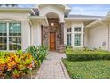 Inviting front entrance with stone accents, a wooden door, and colorful landscaping at 204 S Trask St, Tampa, FL 33609
