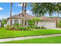 Charming single-story home boasts lush landscaping, manicured lawn, and a two car garage at 2238 Shirecrest Cove Way, Lutz, FL 33558