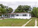 Charming single-story home featuring a carport, freshly painted exterior, and a well-manicured lawn at 2324 W Marquette Ave, Tampa, FL 33604