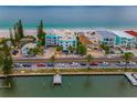 An aerial view of the condo complex next to the beach with turquoise water and neighborhood views at 24 Gulf Blvd # 1C, Indian Rocks Beach, FL 33785