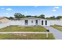 Single-story home featuring a well-manicured lawn and a classic, welcoming entrance at 2408 Wishing Well Way, Tampa, FL 33619