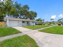 Exterior of home showing landscaping, lawn and large driveway at 2432 Keene Park Dr, Largo, FL 33771