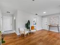 Open-concept living room with hardwood floors, modern furniture, and neutral decor at 2432 Keene Park Dr, Largo, FL 33771