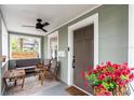 Inviting front porch includes neutral furnishings, stylish ceiling fan and attractive door at 2439 6Th N Ave, St Petersburg, FL 33713