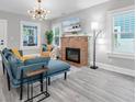 Bright living room boasts a brick fireplace, modern lighting, and large windows at 2439 6Th N Ave, St Petersburg, FL 33713