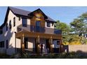 Stylish two-story house with a wood-accented balcony and sleek architectural design, enhanced by landscape at 2501 Quincy S St, St Petersburg, FL 33711