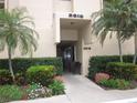 Inviting condo entrance with lush landscaping and seating at 2616 Cove Cay Dr # 104, Clearwater, FL 33760