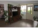 Bright living room featuring a large entertainment center and natural light at 2616 Cove Cay Dr # 104, Clearwater, FL 33760