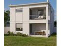 Modern home showcasing a balcony, a covered patio with a dining area, and an expansive backyard ideal for outdoor enjoyment at 2932 Fairfield S Ave, St Petersburg, FL 33712