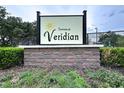 Attractive community sign for Townes at Veridian with brick base and manicured landscaping at 30729 Veridian Way, Wesley Chapel, FL 33543