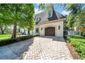 Attached two-car garage with brick-paved driveway and manicured landscaping at 3144 W Waverly Park, Tampa, FL 33629