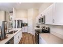 Bright kitchen featuring stainless steel appliances, white cabinets, and an eat-in counter at 36953 Sagemoor Dr, Zephyrhills, FL 33541