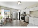 Modern kitchen with stainless steel appliances, white cabinets, and plenty of natural light at 4506 La Capri Ct, Tampa, FL 33611