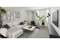 Bright living room featuring a comfortable white sectional sofa, stylish decor, and large window at 4506 La Capri Ct, Tampa, FL 33611