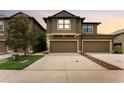Two-story townhome featuring a two-car garage and neutral-toned exterior paint at dusk at 5153 Bay Isle Cir, Clearwater, FL 33760