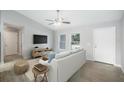 Bright living room with wood-look tile flooring, ceiling fan, and a comfortable sofa with stylish decor at 5319 Lantana St, Zephyrhills, FL 33542