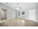 Bright living room with tile floors, a ceiling fan, and plenty of natural light at 5319 Lantana St, Zephyrhills, FL 33542