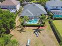 An aerial view of the backyard, showcasing a screened-in pool, a seating area, and a playground at 5813 Bent Grass Dr, Valrico, FL 33596