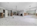 Open living space showcasing a brick fireplace and an airy layout with multiple doorways and large windows at 5871 Oakhurst Dr, Seminole, FL 33772