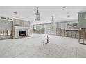 Spacious living room featuring a whitewashed brick fireplace, recessed lighting, and french doors to the outdoor space at 5871 Oakhurst Dr, Seminole, FL 33772