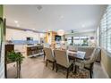 Open-concept living space with tile floors, dining area, and a modern kitchen with stainless steel appliances at 6031 Grand Sonata Ave, Lutz, FL 33558