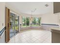 Sunny breakfast nook with tile flooring, large windows offering backyard views, and access to the patio at 6058 Waycross Dr, Spring Hill, FL 34606