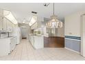 Functional kitchen with white appliances, tile flooring, and ample cabinet space, ready for modern upgrades at 6058 Waycross Dr, Spring Hill, FL 34606