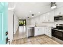 Bright kitchen with modern, stainless appliances and a beautiful view of the living room and back patio at 9142 Oakwood Ln, Seminole, FL 33776