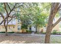 Two-story exterior showcasing the property's architecture and landscaping with mature trees at 962 Sombra St, Tampa, FL 33619